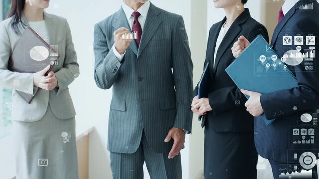 A group of male and female business professionals conversing in an office, and the concept of digital technology.