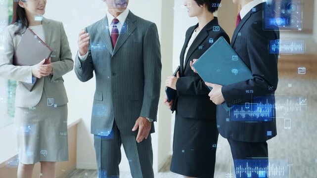 オフィスで会話する男女ビジネスパーソンのグループとデジタルテクノロジーのコンセプト