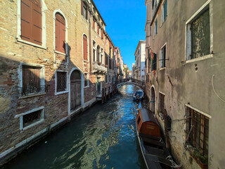 Traditional gondola moored in a quiet Venetian canal © tsb