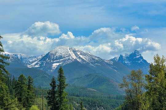 Spring Snow under a Beautiful Cloudscape on Wolftail Mountain in Glacier National Park in Montana.  Mount 
Doody can be seen on the Right.