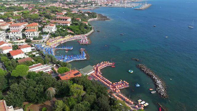 high turning aerial of Castiglioncello, Italy, showing the best of the resort strewn coastal beauty in perfect lighting near golden hour