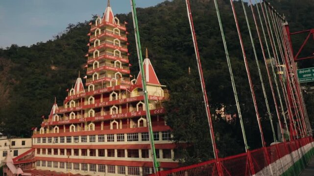 Scenic view of the famous thirteen-story Tera Manzil Hindu Temple, also known as Trimbakeshwar, located on the banks of the Ganges river in the holy city of Rishikesh, India