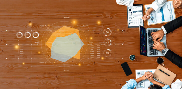Business professionals engage in data analysis and decision-making at a modern workspace. Financial documents, interactive graphs, and hands-on collaboration create a productive environment. Trope