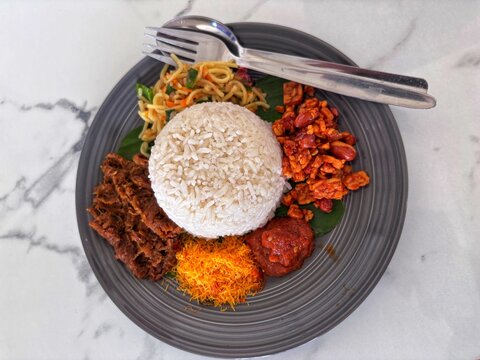 Enjoy the authentic, rich flavors of traditional Indonesian Nasi Campur, a truly delightful culinary experience