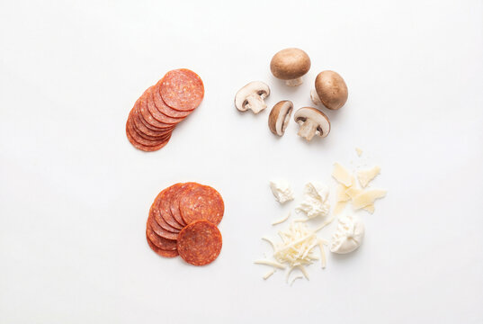 Flat lay of modern pizza ingredients with pepperoni mushrooms and cheese