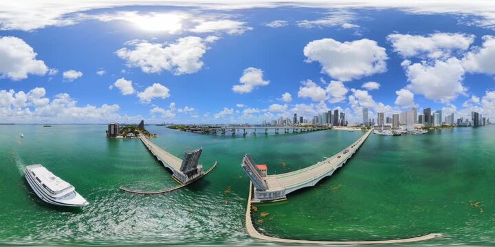 Aerial 360 VR footage of yachts going under an open bridge Miami scene