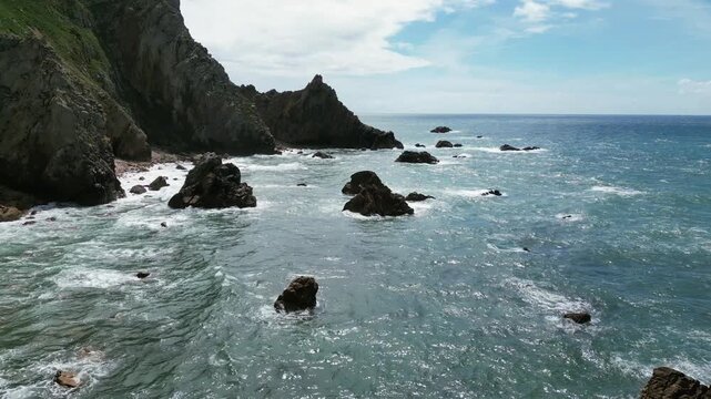 Aerial drone footage of Praia da Ursa, Portugal: dramatic sea stacks, Atlantic waves and rugged coastal scenery under natural light. Ideal for travel and nature projects.