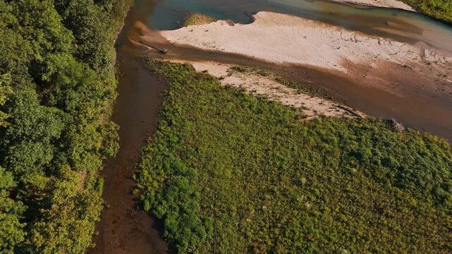Aerial shoreline vegetation with mud and sand deposition beside Bush Creek Bay connecting to Lake Eucha waters