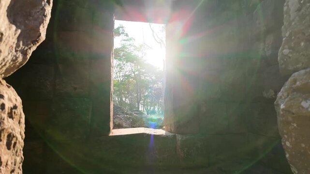 Golden Sunbeams Piercing Through Stone Windows of Ancient Khmer Ruins, Phanom Rung Historical Park, Buri Ram, Thailand