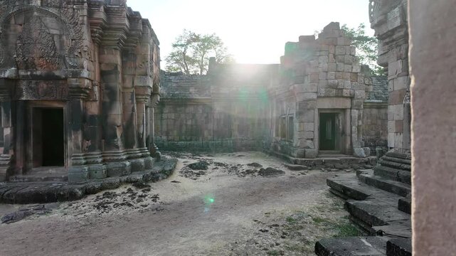 Interior POV of Ancient Temple Sanctuary Looking Out Window with Golden Lens Flare, Phanom Rung Khmer ruins in Buri Ram, Thailand