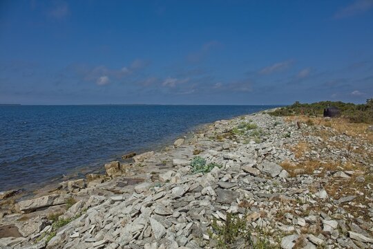 Rocky limestone shoreline landscape of Elda Pank (Elda cliff) in sunny summer weather, Saaremaa, Estonia, Europe.