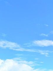 Fototapeta premium Minimalist calm blue sky background with soft white clouds texture copy space wallpaper concept