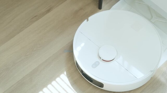 AI robot vacuum cleaner cleaning bright wooden floor, smart home technology for effortless household chores and floor care.