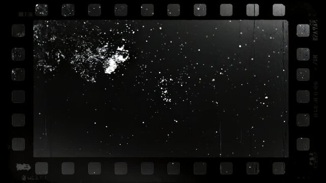 黒背景に白いフィルムダストが静かに漂うネガフィルム風ミニマル背景アニメーション