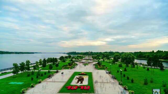 Yaroslavl, Russia. Strelka Park at the confluence of the Volga and Kotorosl rivers, time-lapse transition from sunset to night with illuminated fountains and floral emblem, TimeLapse