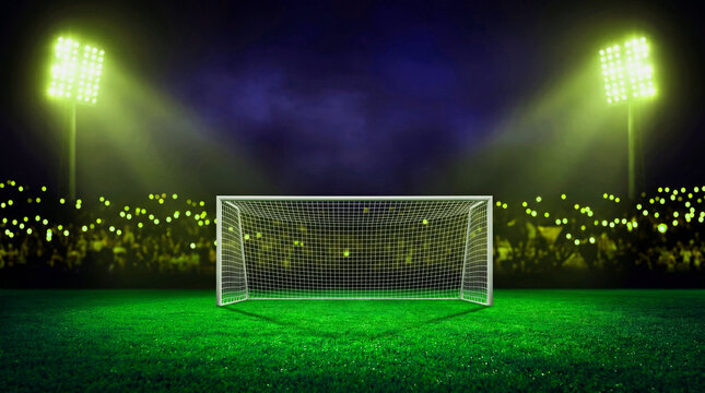 A bright soccer stadium field with green grass under a dark night sky filled with clouds and abstract spotlights