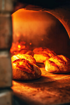 Rustic Bread Baking in Traditional Wood Fired Oven. AI generative.