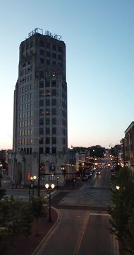 Vertical aerial drone video of car traffic at night in downtown Elgin, Illinois.