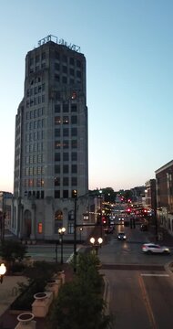 Vertical aerial drone video of car traffic at night in downtown Elgin, Illinois.