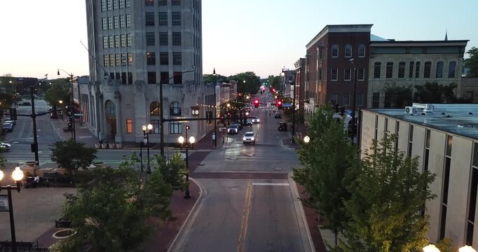Aerial drone video of car traffic at night in downtown Elgin, Illinois.