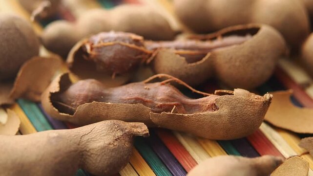 Discovering tamarind fruit on a colorful table