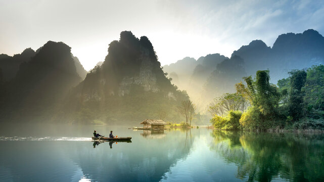 Small boat on river with limestone mountains in vietnam