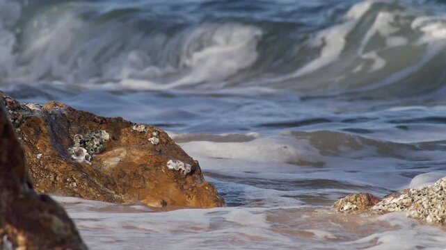 Powerful Sea Surf Crashing Against Coastal Rocks at Shoreline
