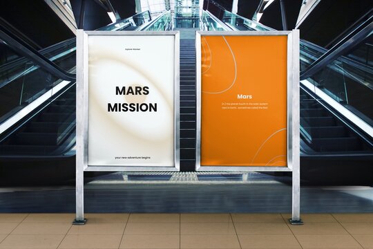 Two posters in a subway station, one white and one orange, about Mars.
