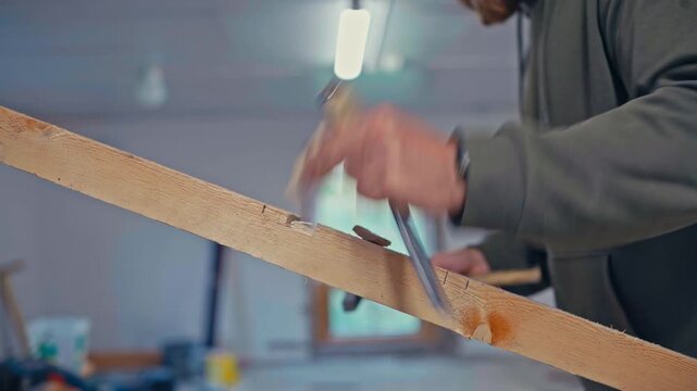 A Craftsman is Using a Chisel to Carve Precise Notches Into a Wooden Beam - Close Up