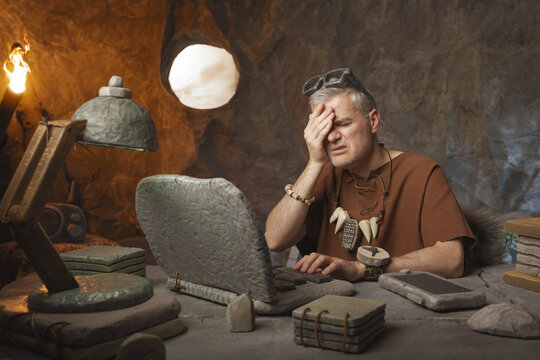 Prehistoric office worker having a bad headache