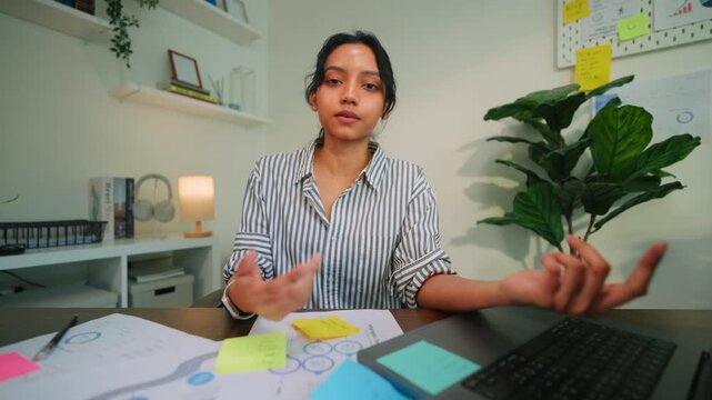 Businesswoman Taking Notes During Team Meeting