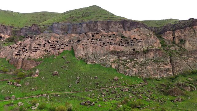 Drone of Vardzia cave monastery, Georgia ancient rock-hewn fortress carved into Erusheti Mountain slopes above the winding Mtkvari River