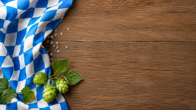 Oktoberfest Background with Bavarian Napkin and Hops on Wood