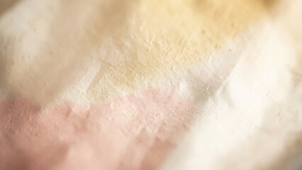 Fototapeta premium Linen fabric surface texture featuring a delicate blend of cream and pale pink