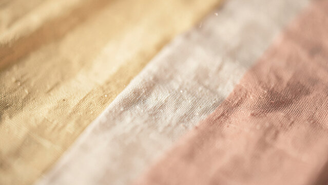 Gentle warmth of woven textile blending golden beige and soft blush tones