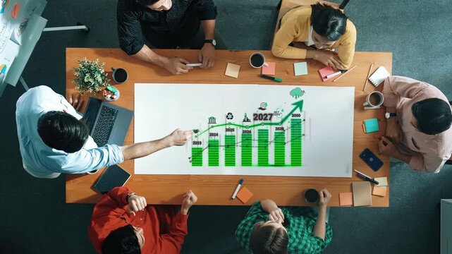 Team Collaboration on Business Strategy Presentation with Focus on Growth Graph and Future Projections in a Modern Office Environment Sigmoid