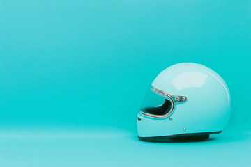 Fototapeta premium Retro full face motorcycling helmet isolated on cyan background with copy space