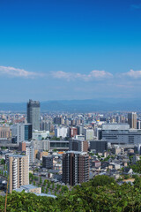 Fototapeta premium Panoramic view of the cityscape around Kumamoto Station from a hill in May, no people