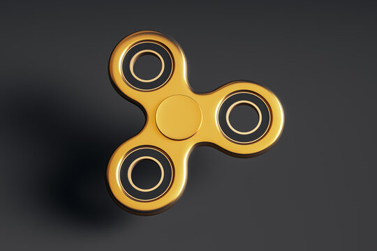 Golden fidget spinner isolated on dark background with metallic shine and smooth surface highlighting modern toy design and style.. 3D Rendering