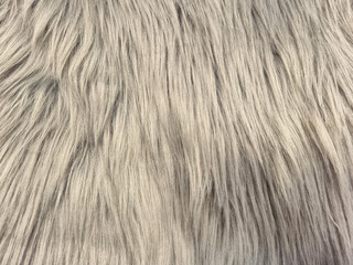 Fototapeta premium Close-up texture of soft, fluffy, light gray faux fur material