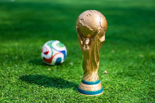 May 7, 2026, United States. The trophy of the 2026 FIFA World Cup and the official Adidas Trionda ball on the green lawn of the stadium.
