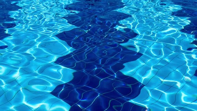 Crystal clear blue water texture with sunny ripples in a luxury 5-star resort swimming pool. Premium background for summer vacation and tropical wellness concepts in Sharm El Sheikh, Egypt.