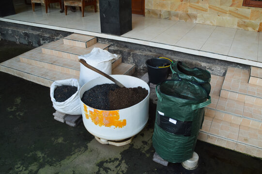 Extreme high left angle terrace view displaying planting media preparation with fermented soil, charcoal husk stock, compost bags, and mixing container.