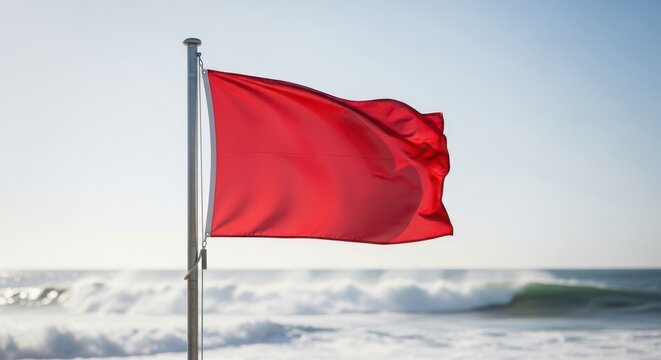 Red flag warning beach safety signal with rough seas coastal hazard and rip current alert