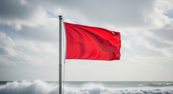 Red flag warning high risk conditions at the beach with strong waves and stormy weather