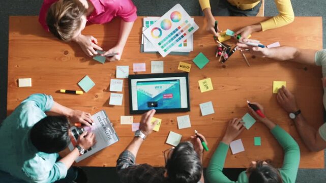 Time lapse of smart business people working together to design web design. Aerial view of designer brainstorming and discussing about website interface for computer or digital application. Symposium.