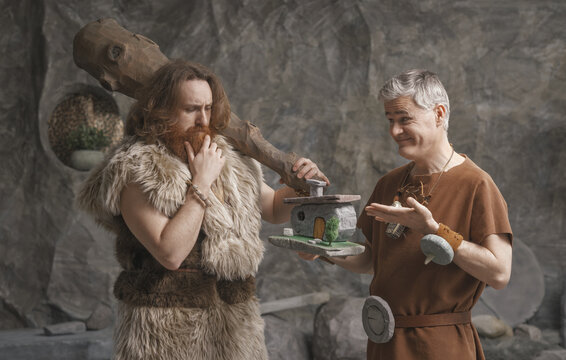 Stone Age real estate agent persuading a customer to buy a house