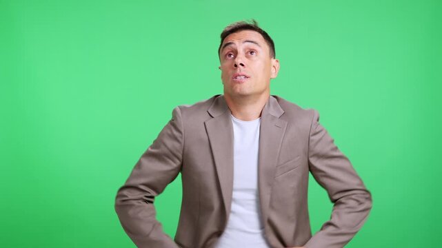 Confused man shrugging shoulders on green screen