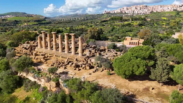 Standing ancient columns and stone ruins overlook Agrigento at the Valley of the Temples archaeological park in Sicily, Italy.