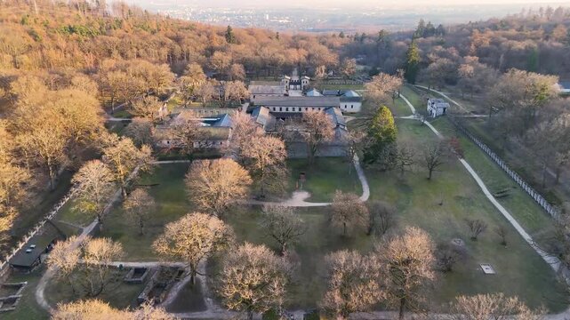 Top-down drone image of reconstructed stone buildings, courtyards, paths, and walls at Saalburg Roman Fort in Hesse, Germany.